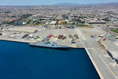 High angle view of buildings by sea against sky port terminal 