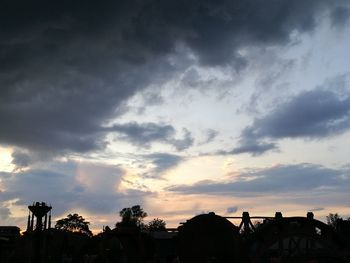 Silhouette of buildings against cloudy sky