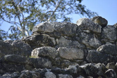 Low angle view of rocks against clear sky