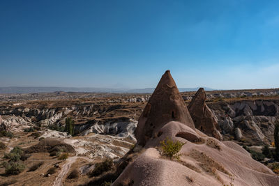 Rock formations on landscape against clear sky