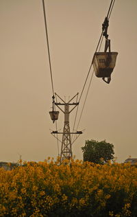 Low angle view of overhead cable car against sky