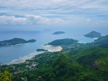 Scenic view of sea and mountains against sky