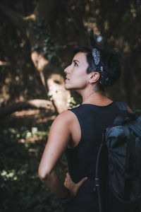 Portrait of young couple looking away in forest