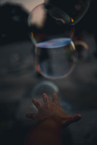 Close-up of hand holding bubbles