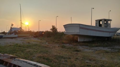 Boats moored at sunset