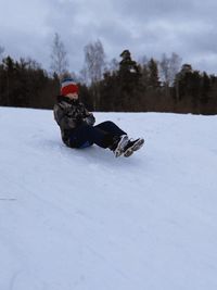 Rear view of man skiing on snow