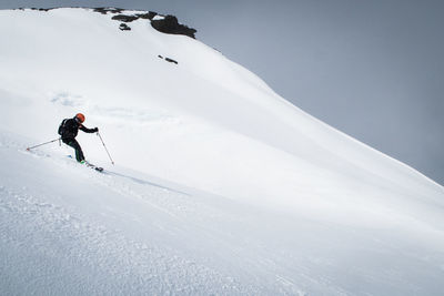 Man skiing on snowcapped mountain