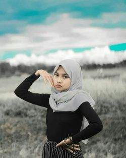 Young woman standing on field