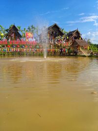Scenic view of lake by building against sky