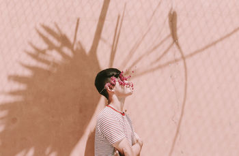 Portrait of man standing against wall