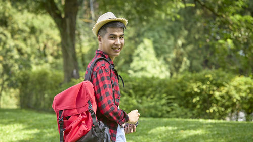 Portrait of smiling young man standing outdoors