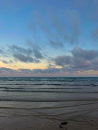 Scenic view of beach against sky during sunset