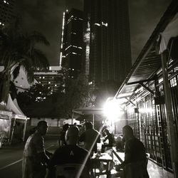 People on stage in city at night