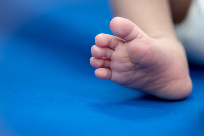 Low section of baby foot on bed