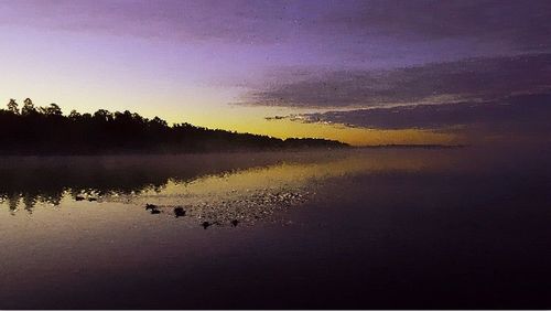 Scenic view of lake at sunset