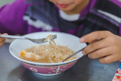 Midsection of woman holding ice cream in bowl