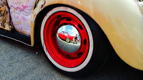 Close-up of red car on road