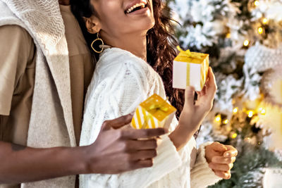 A happy couple of mulattoes exchange gifts with each other. celebrating joint family events