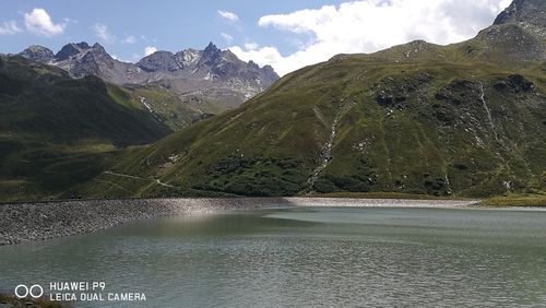 Scenic view of lake and mountains against sky