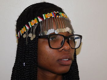 Close-up of young woman wearing headdress and eyeglasses