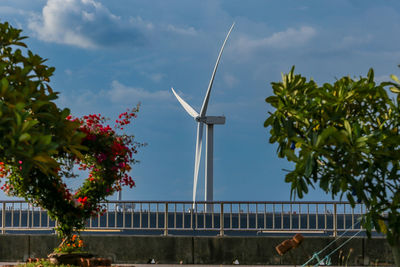 The large vaned wheel rotated by the wind to generate electricity. white windmill of pea 