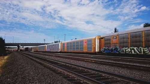 Train at railroad station against sky