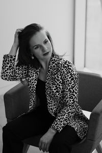 Young woman sitting on sofa at home