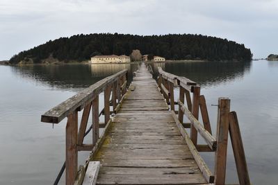 Damaged wooden pier over water against sky in saint mary monastery, zvernec