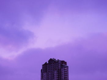 Low angle view of buildings against blue sky