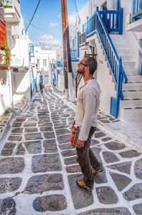 Full length of man standing on footpath