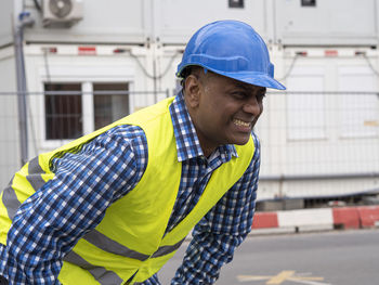 Side view of man standing in city