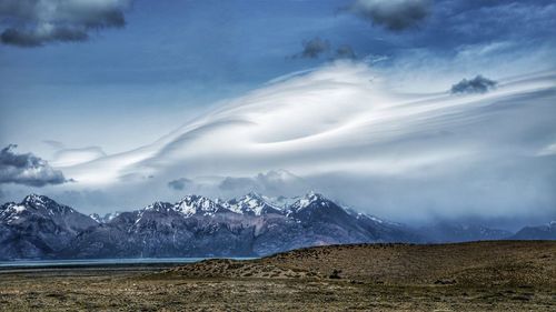Scenic view of snowcapped mountains against sky