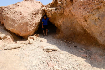 Full length of man standing by rocks