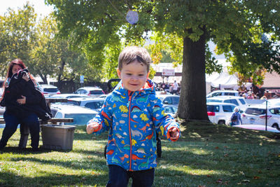 Cute boy walking on field in park