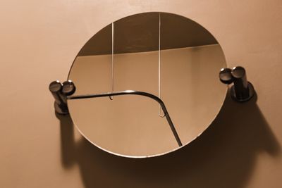 Close-up of electric lamp against wall