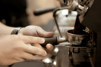 Cropped image of hand holding coffee cup