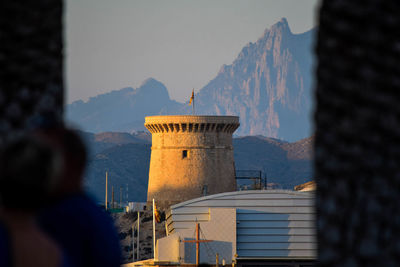 Tower isleta against mountains seen through window