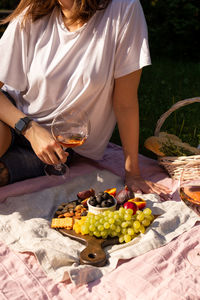 Young woman with wine glass on a summer picnic
