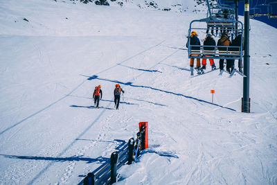 High angle view of people skiing on snow covered mountain