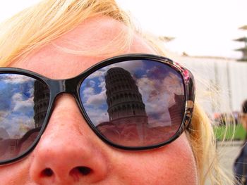 Close-up of woman wearing sunglasses against blurred background