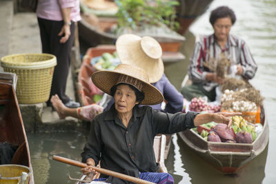 Vendors selling food at floating market