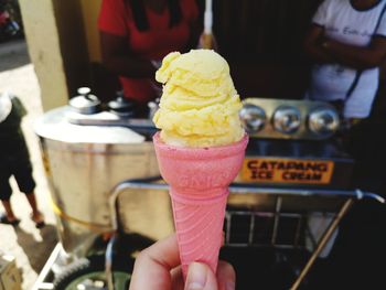 Close-up of hand holding ice cream cone