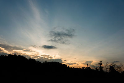 Silhouette trees against sky during sunset