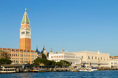 View of buildings in city against clear sky