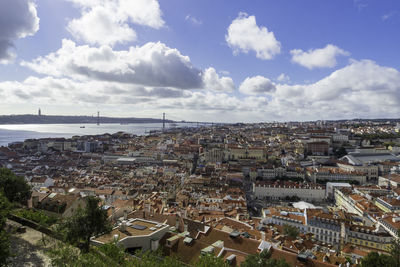 High angle view of townscape by sea against sky