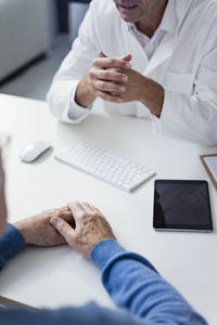 Close-up of doctor talking to senior patient in medical practice