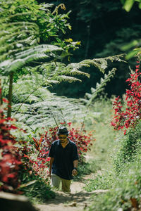 Full length of woman standing against trees