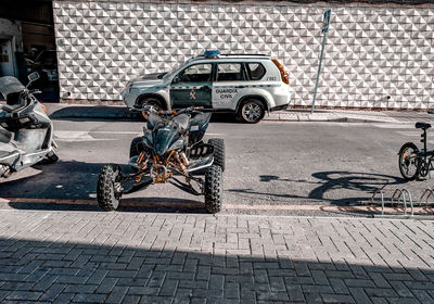 Bicycle parked on footpath by street