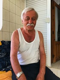 Portrait of smiling man sitting outdoors