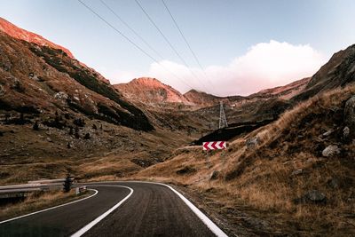 Road amidst mountains against sky